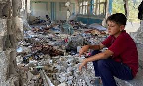 Poor child in tattered clothes looking sad